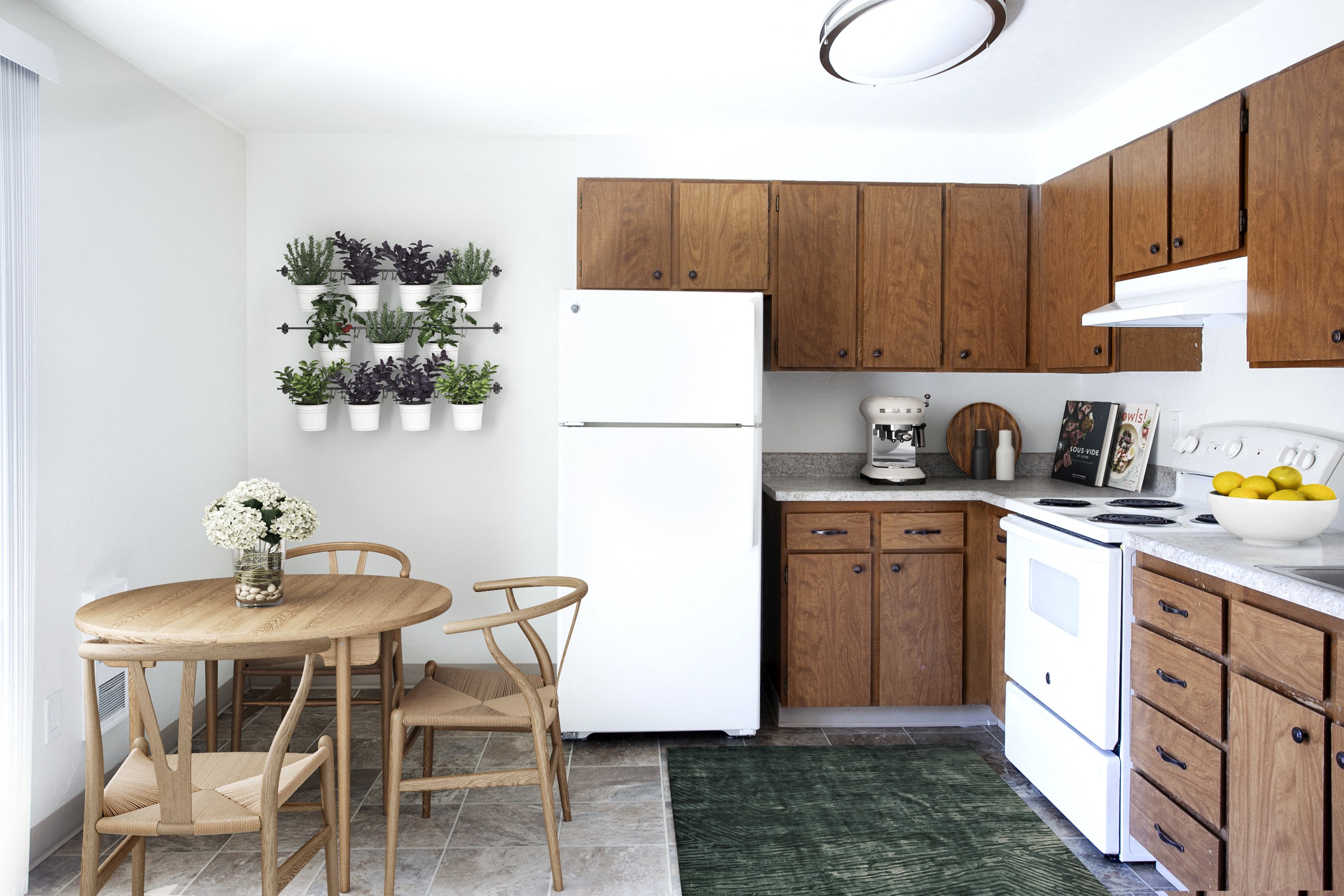 a small kitchen with a table and chairs and a white refrigerator